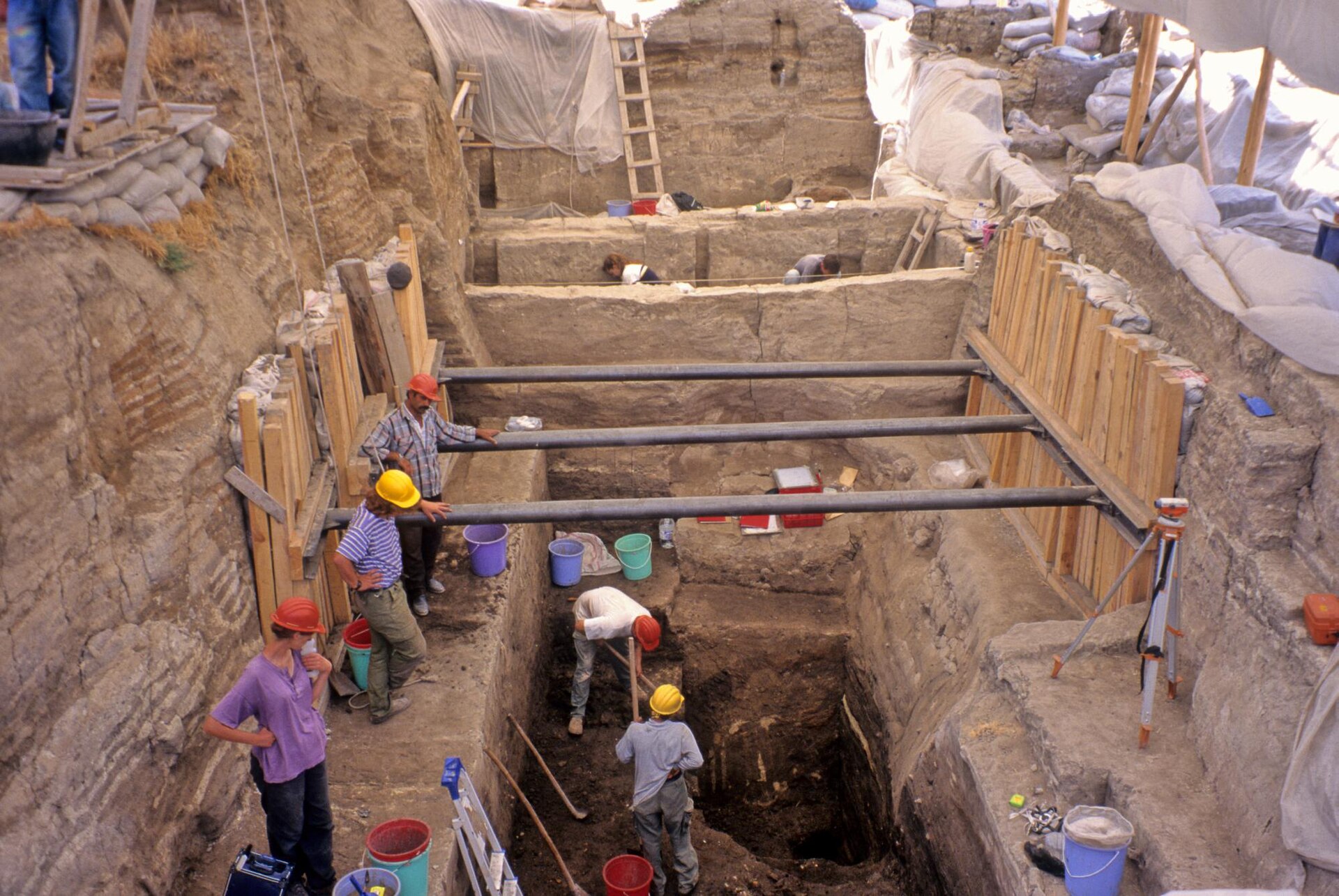 Archaeologists working at different depths in a deep trench at Çatalhöyük